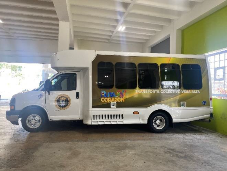 Passenger loading his bicycle on the front of bus