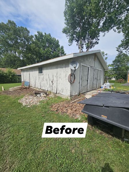 Dilapidated concrete building with peeling paint, surrounded by dirt and grass, marked before.