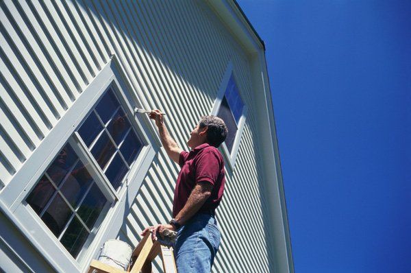 Painting contractor working on painting the wall in Rochester, NY
