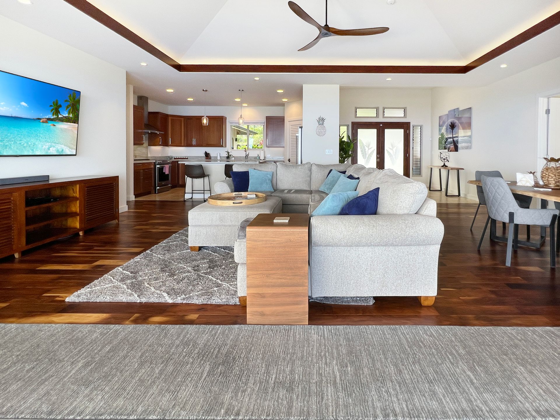 A living room with a couch , chair , table and rug.
