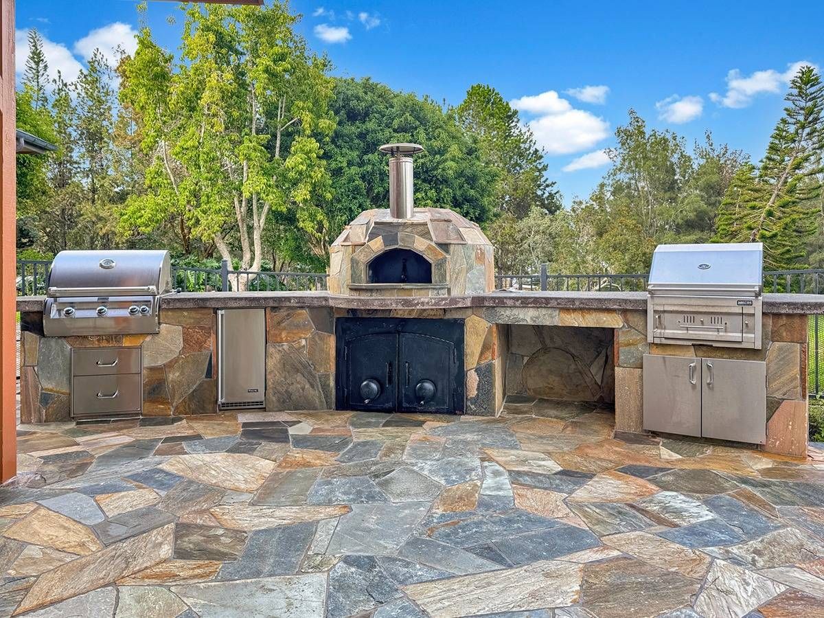 A kitchen with white cabinets and a large island in the middle.