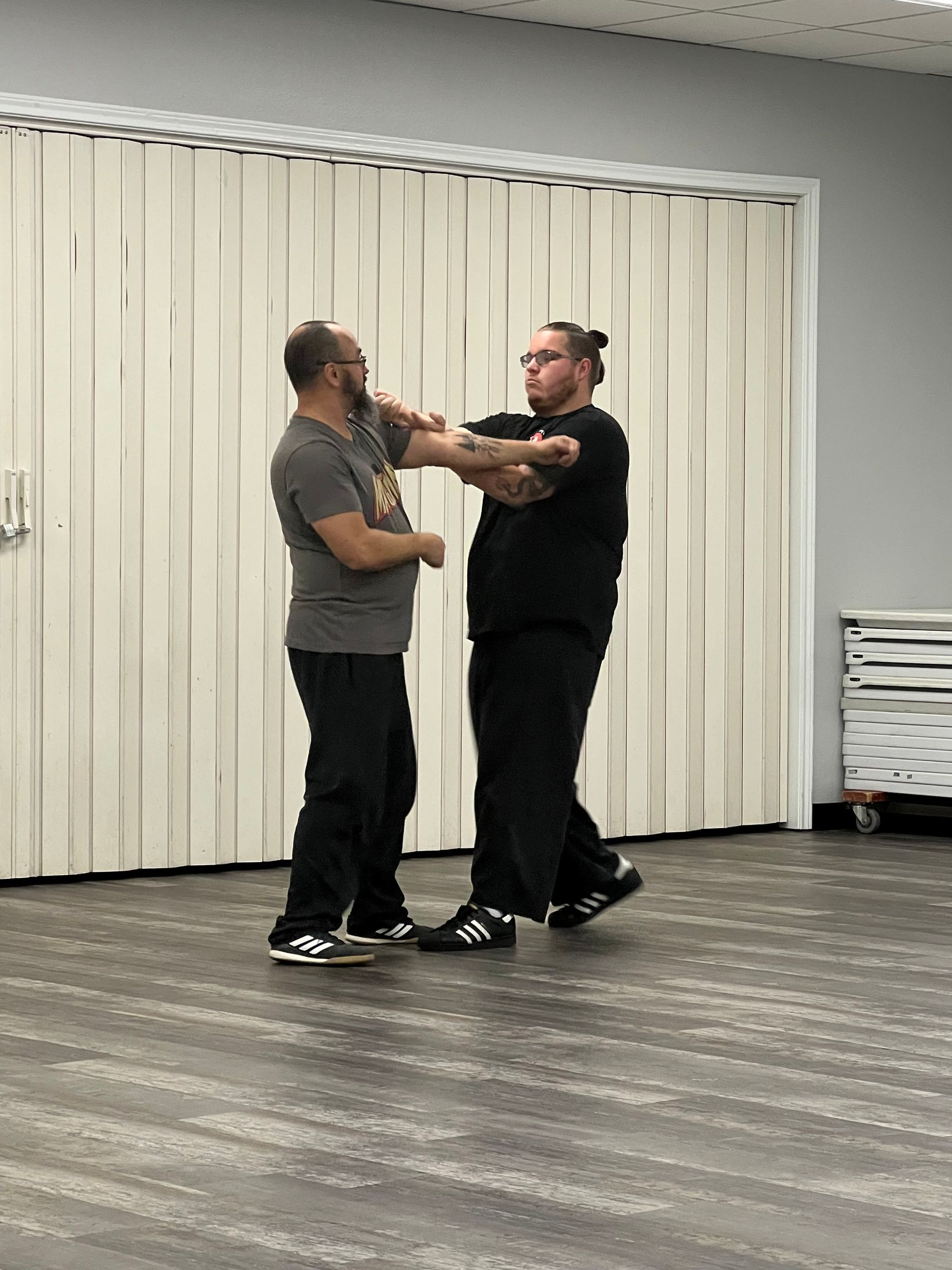 Two men are standing next to each other in a room.