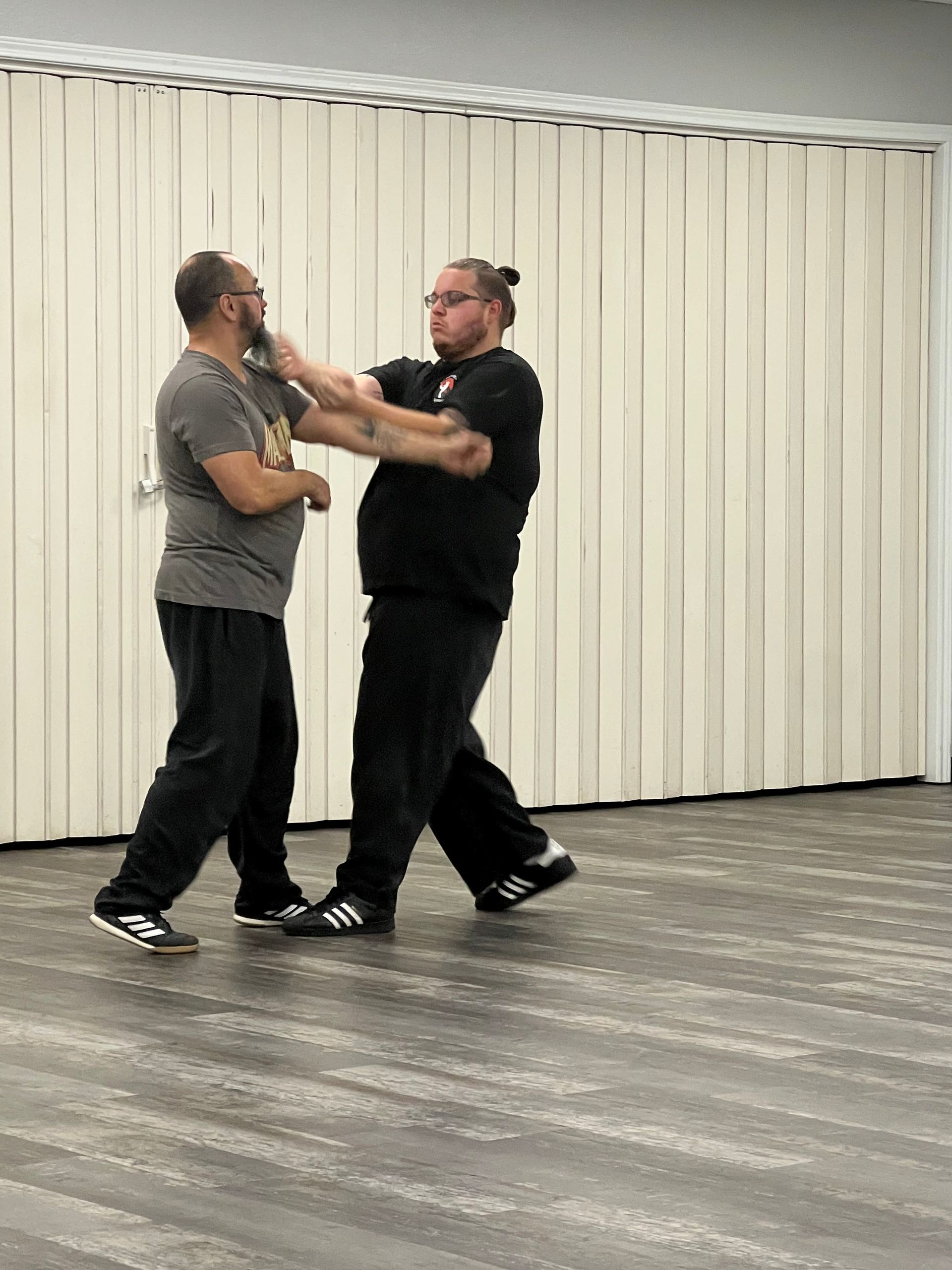 Two men are standing next to each other in a room.