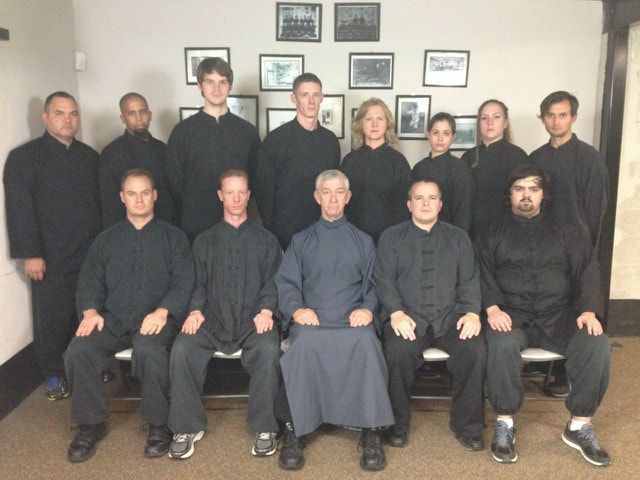 A group of people are posing for a picture in a room