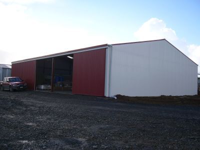 A red and white building with a car parked in front of it.