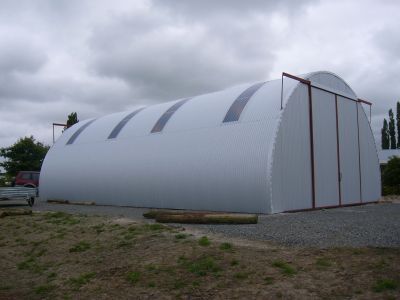 A large white dome shaped building with sliding doors