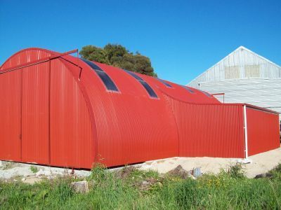A red building with a white building in the background