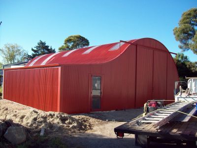 A large red building with a ladder in front of it