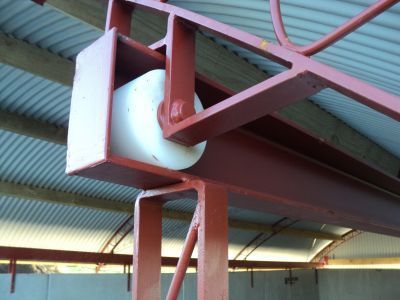 A red metal structure with a white wheel attached to it