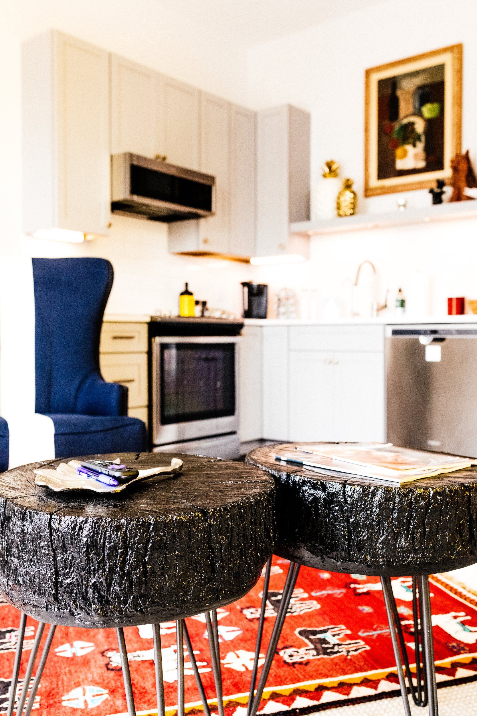 A kitchen with a blue chair and a black table