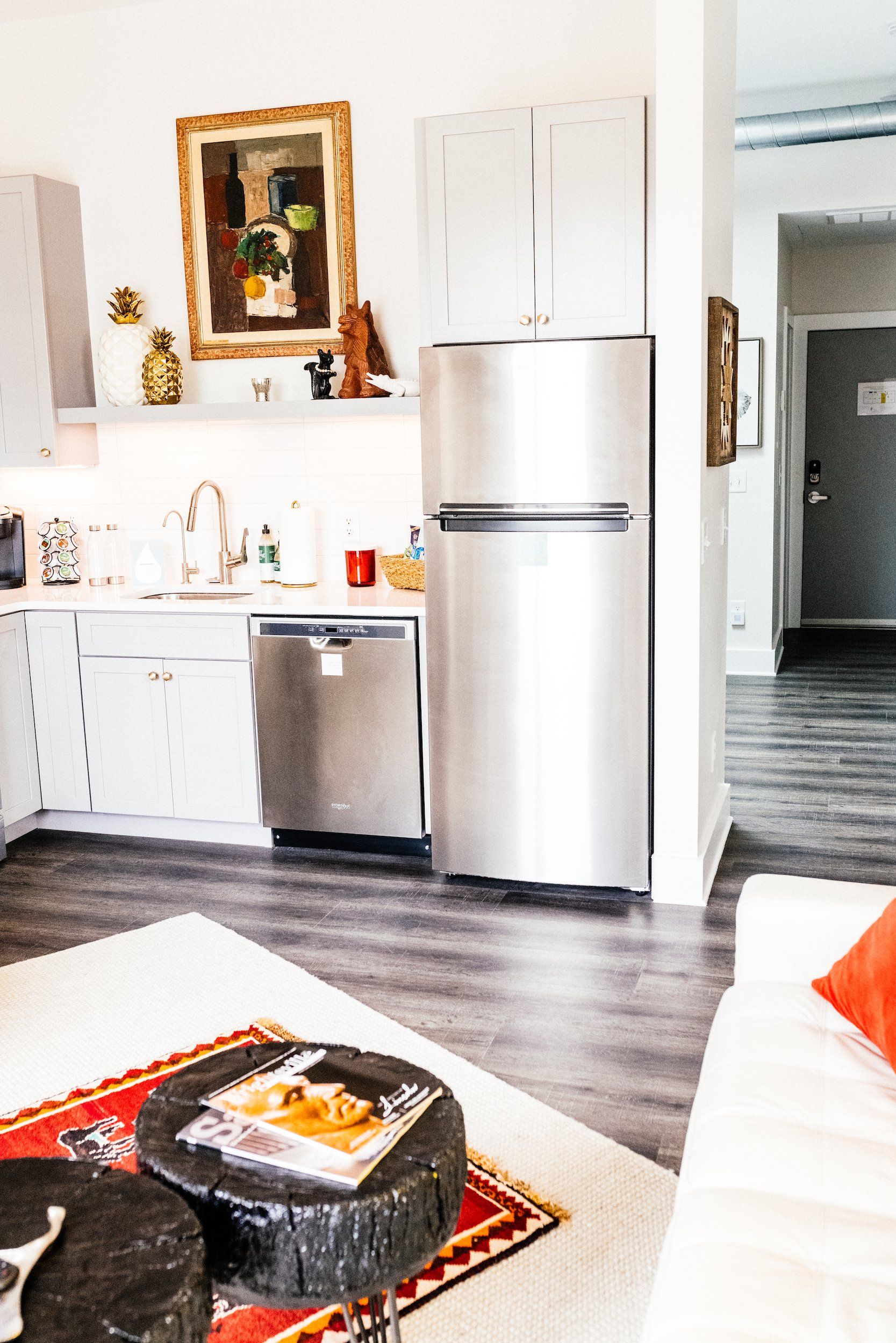 A kitchen with a stainless steel refrigerator and dishwasher