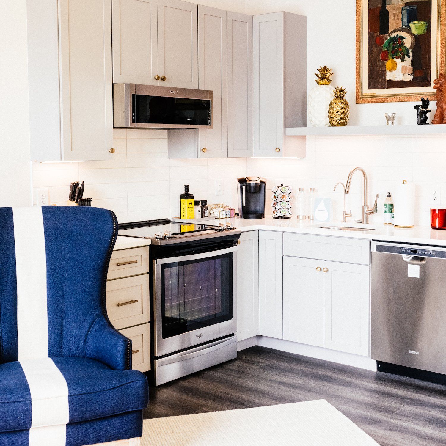 A kitchen with white cabinets and stainless steel appliances