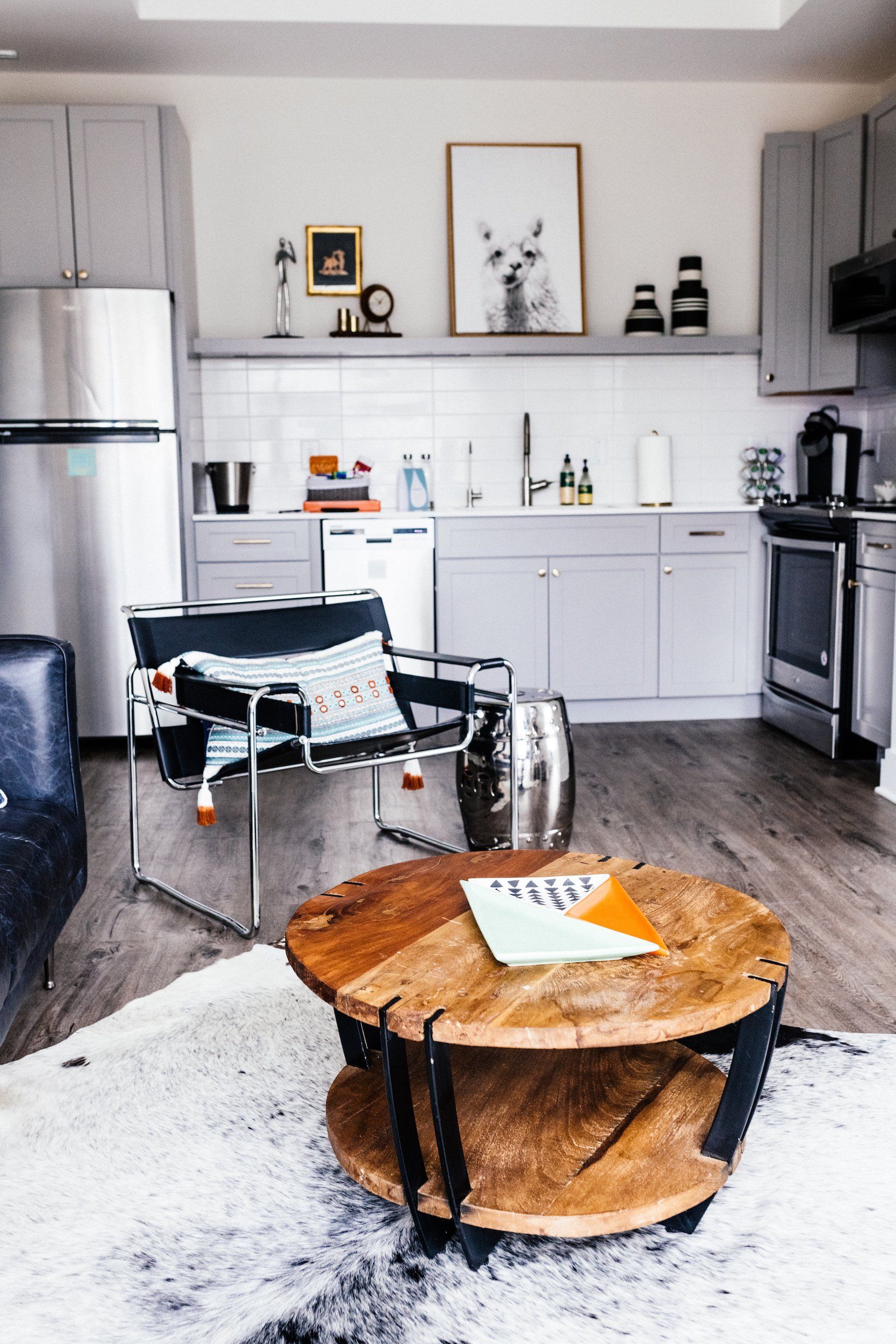 A living room with a round coffee table and a chair