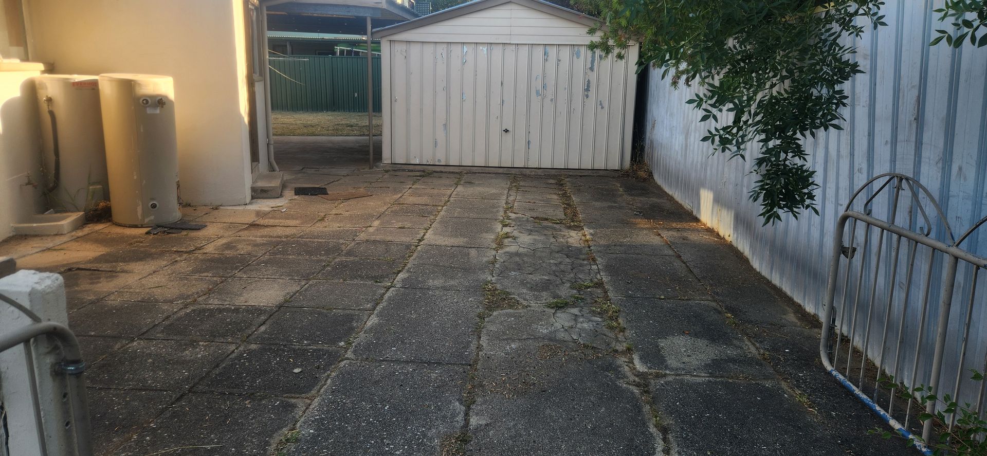 Patio with Concrete Pavers Leading to A White Shed — Carro's Property Maintenance in Gungahlin, ACT