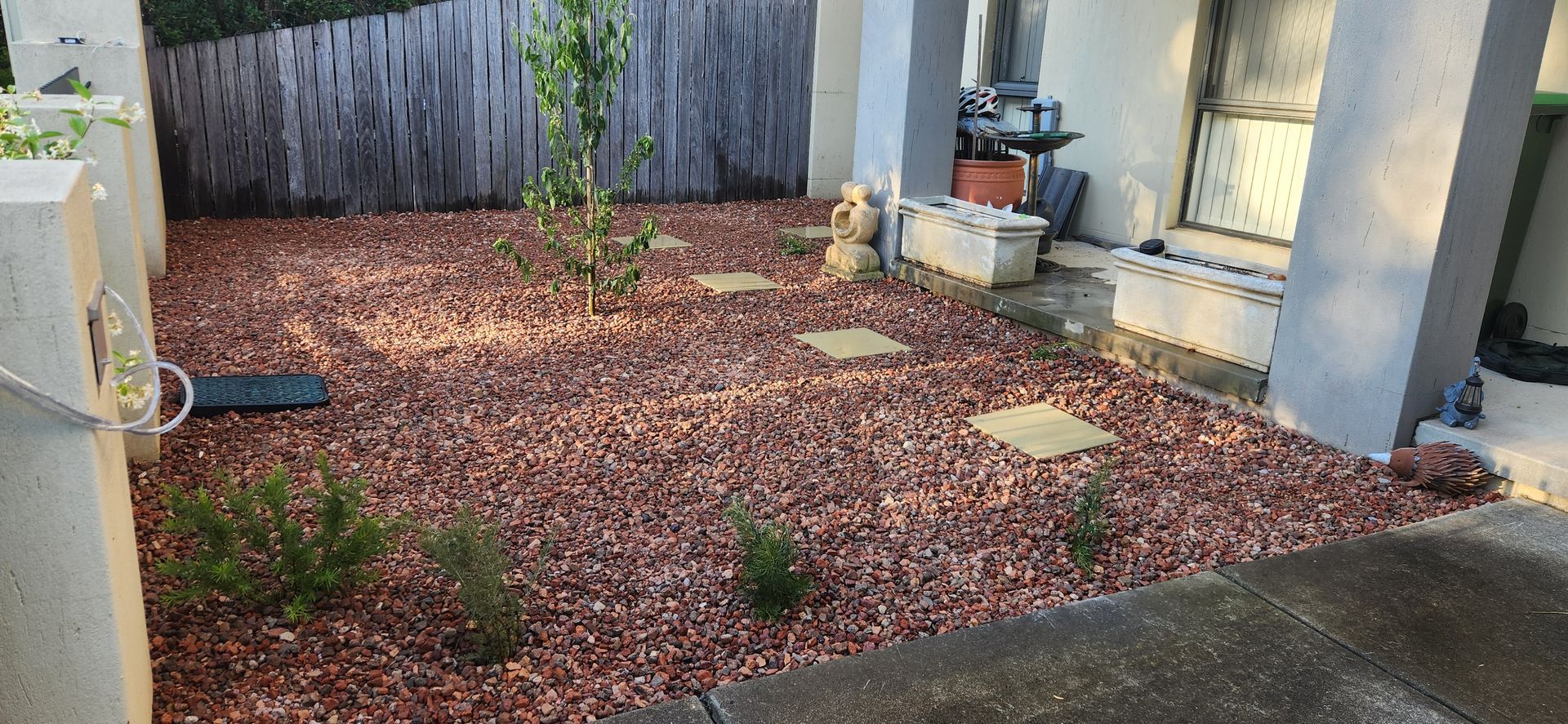 A Small Backyard with Reddish Gravel Ground Cover — Carro's Property Maintenance in Weston Creek, ACT
