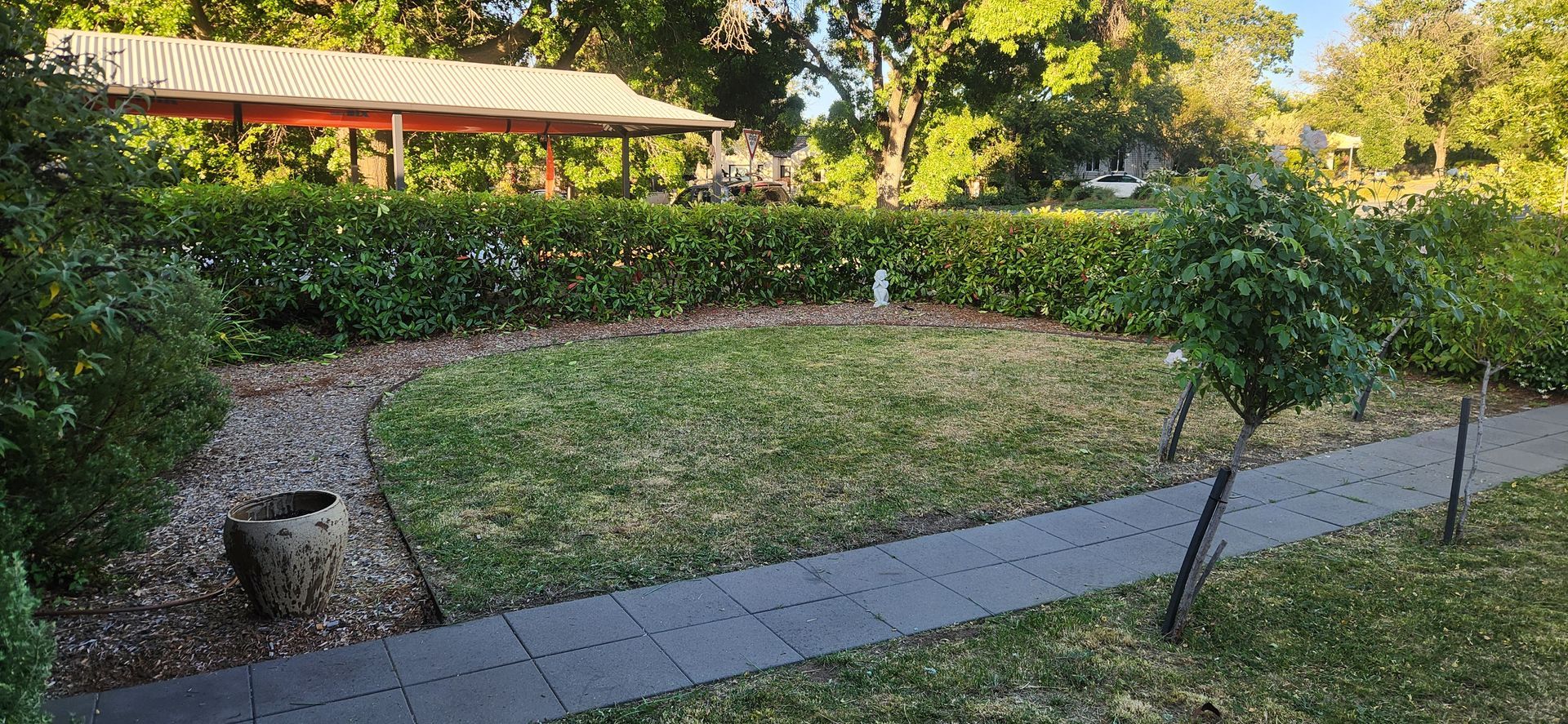 A Garden with A Green Lawn, Sidewalk, and Hedge — Carro's Property Maintenance in Queanbeyan, ACT