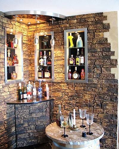 A room with a brick wall and a table with wine glasses on it