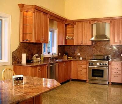 A kitchen with stainless steel appliances and wooden cabinets