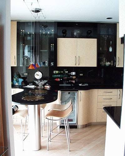 A kitchen with a table and chairs and a refrigerator