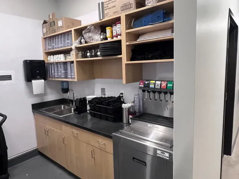 A kitchen with stainless steel appliances and wooden cabinets.