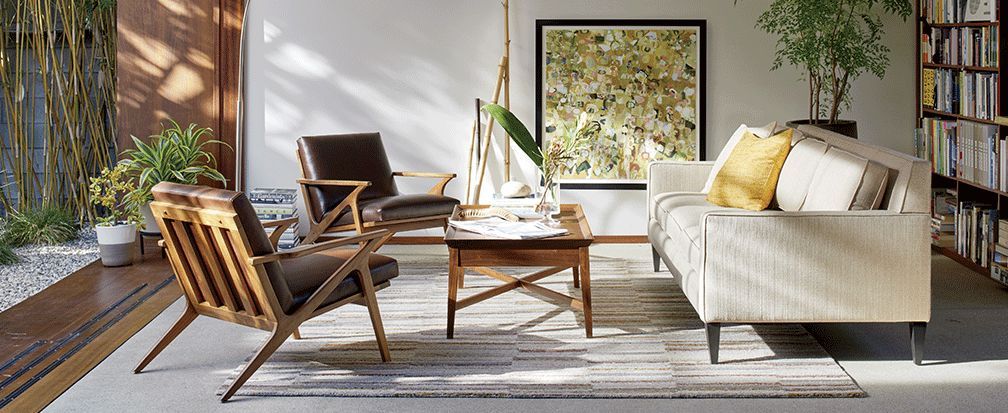 A living room with a couch , chairs , and a coffee table.