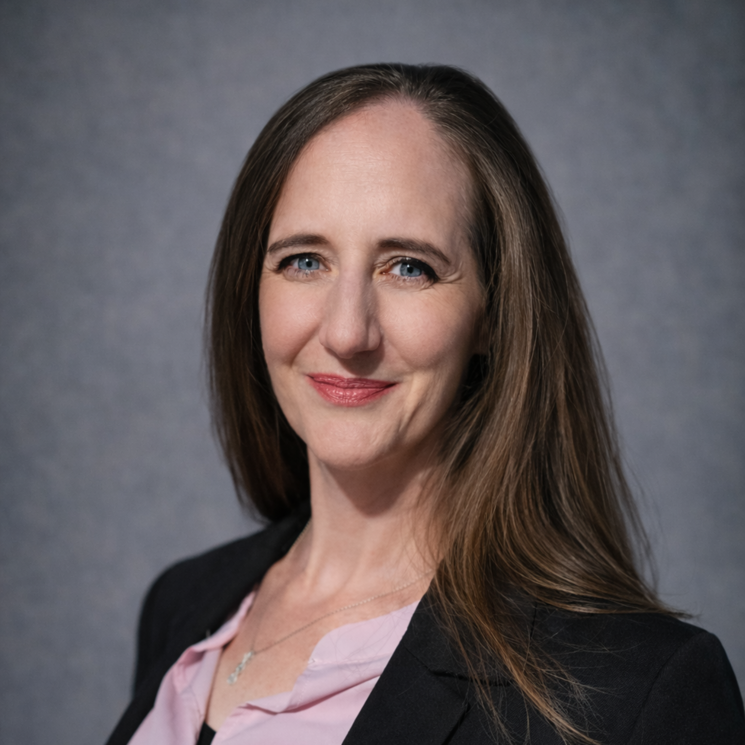 A man in a suit and tie is smiling in front of a window