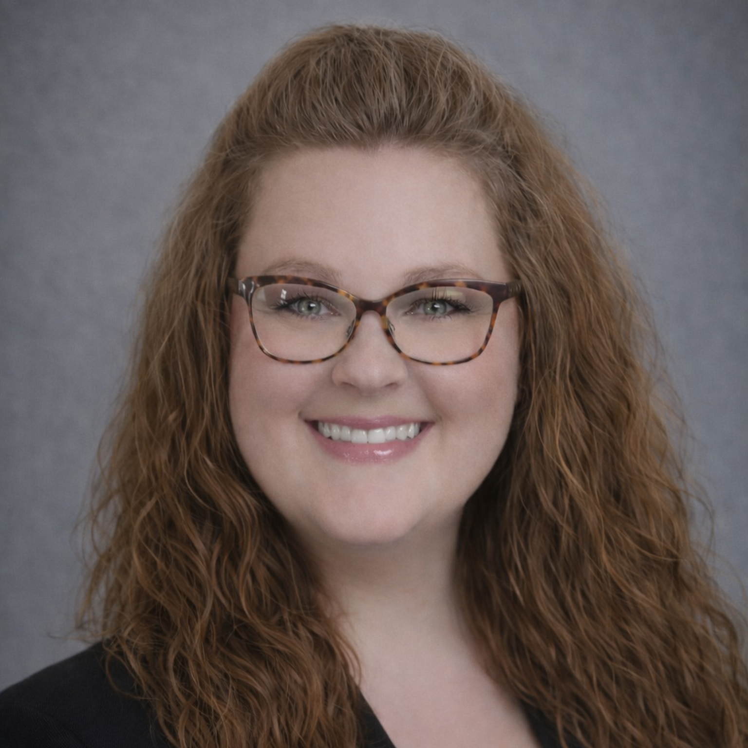 A man in a suit and tie is smiling in front of a window