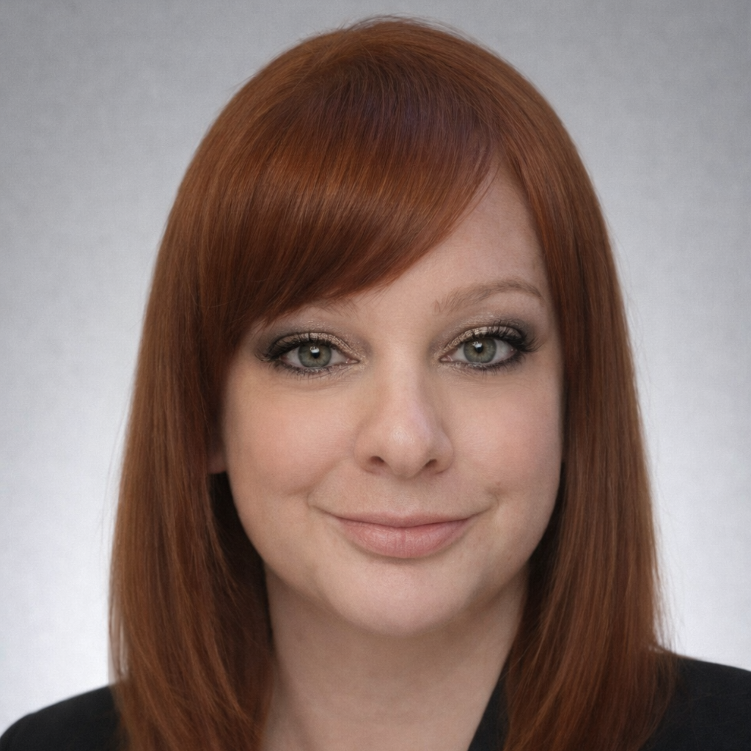 A man in a suit and tie is smiling in front of a window