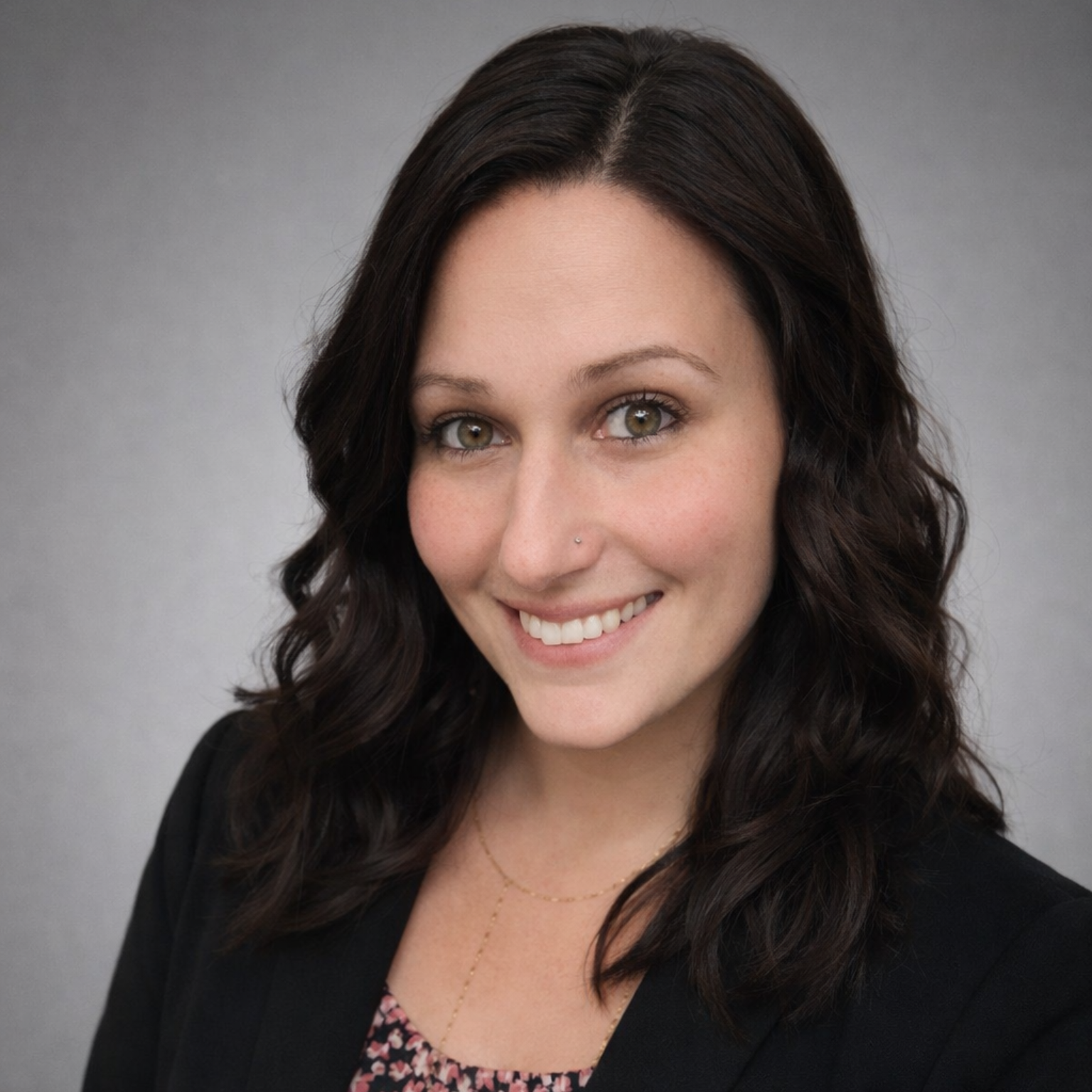 A man in a suit and tie is smiling in front of a window
