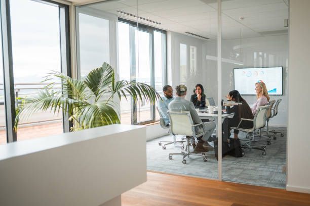 A group of professionals collaborates around a table in a private office suite in Brentwood, TN