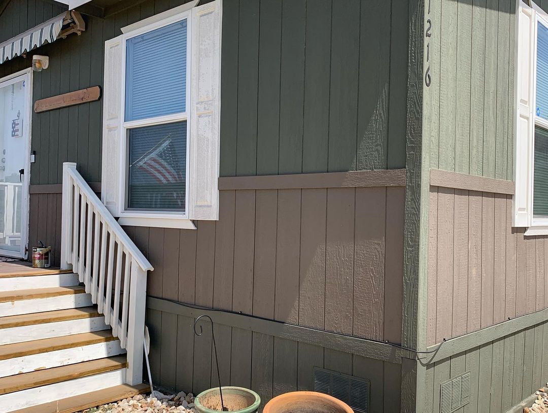 A house with stairs leading up to the front door.