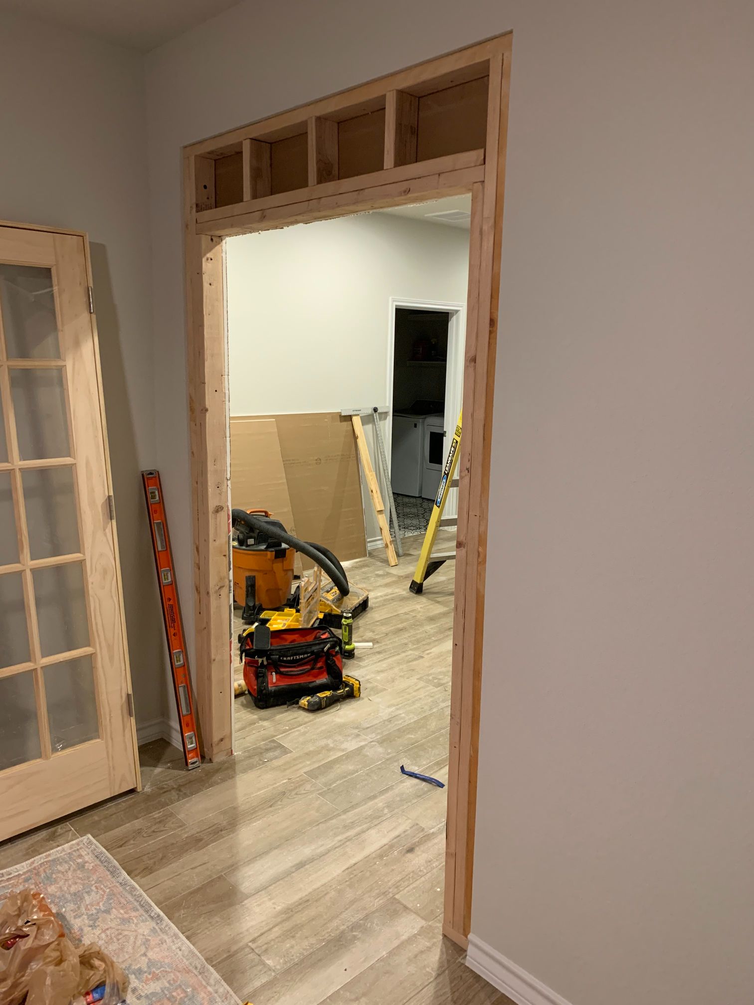 A doorway is being built into a room in a house.