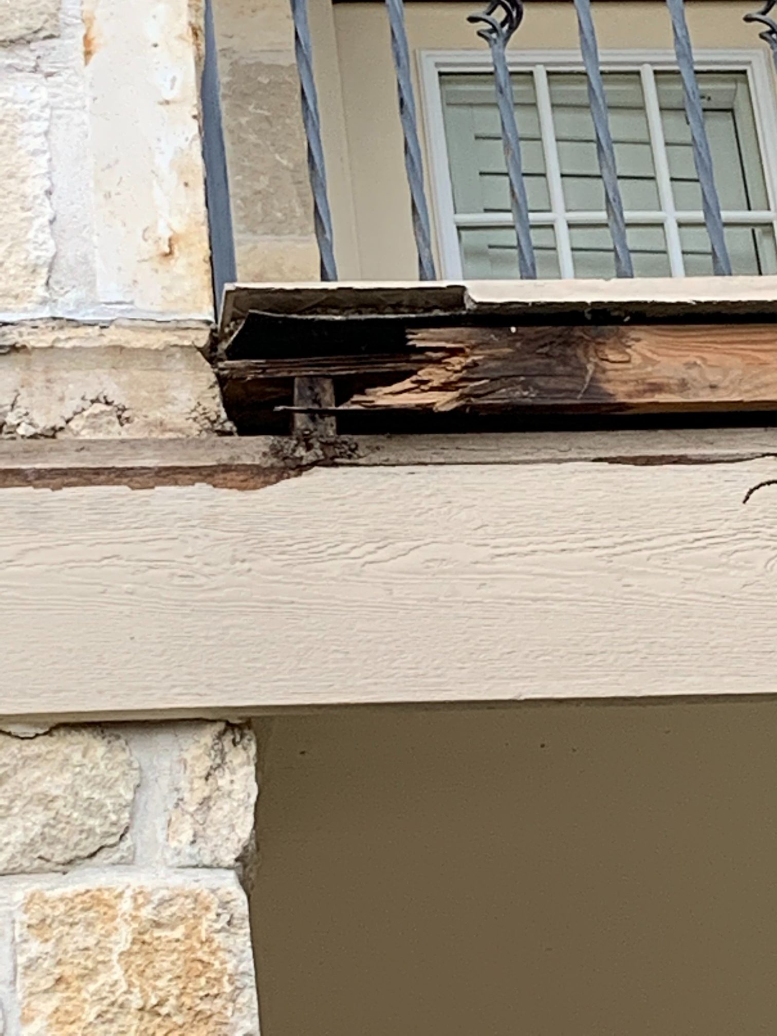 A wooden beam is missing from the side of a building.