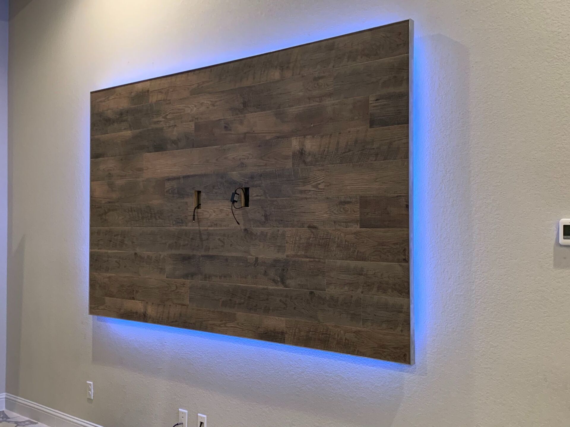 A wooden wall with a blue light behind it.