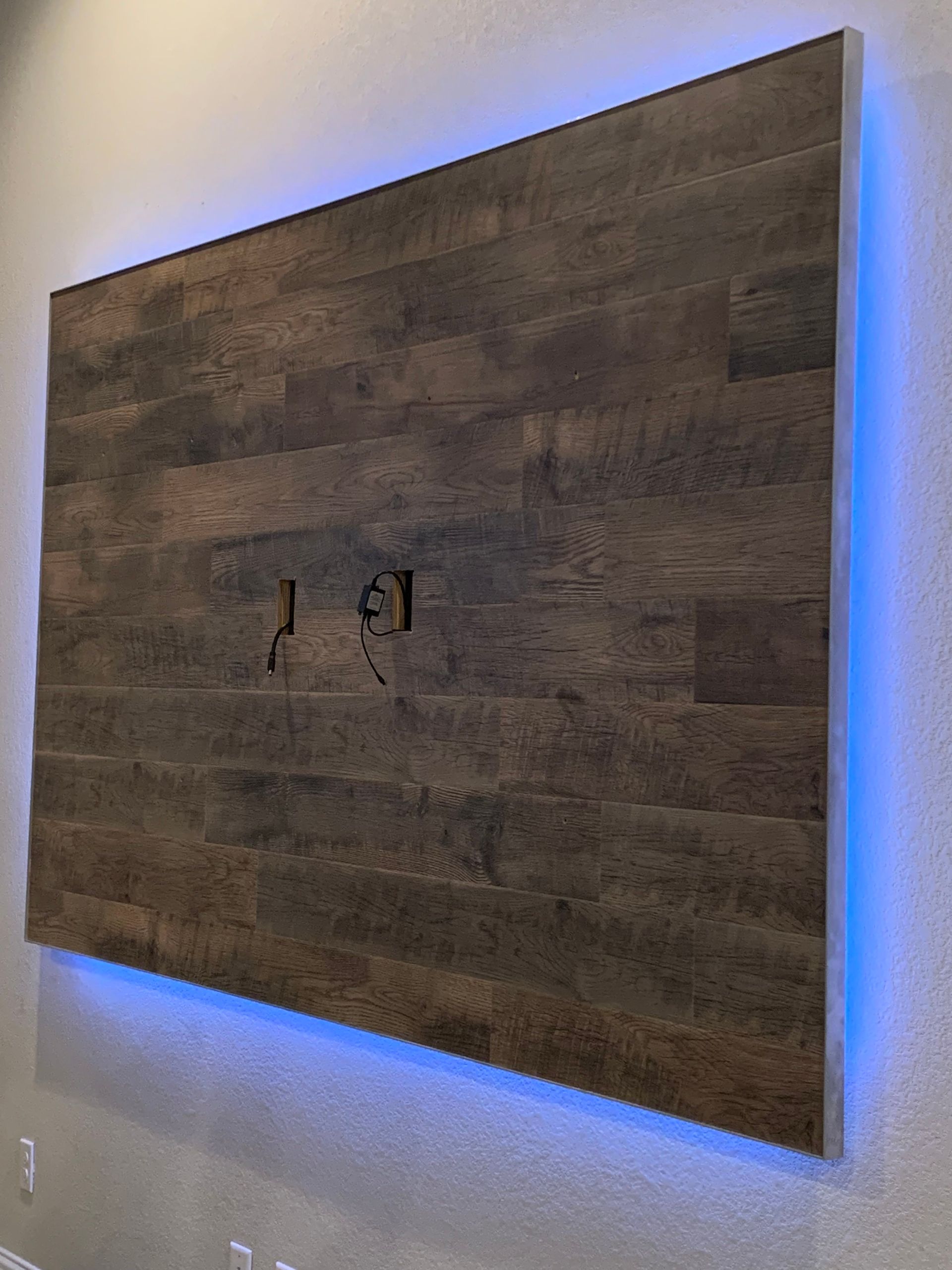 A wooden wall with a blue light behind it.