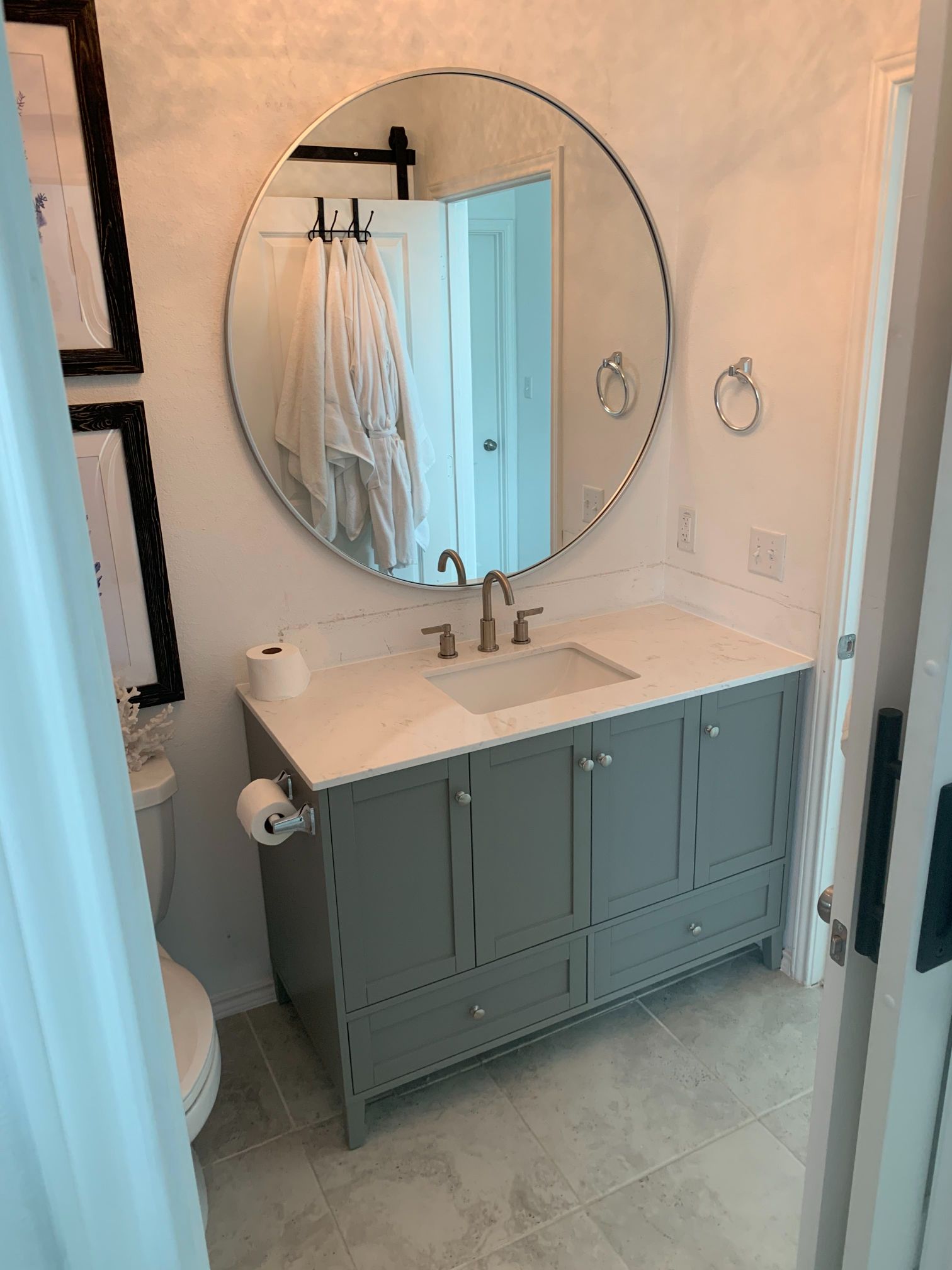 A bathroom with a sink , mirror and toilet.