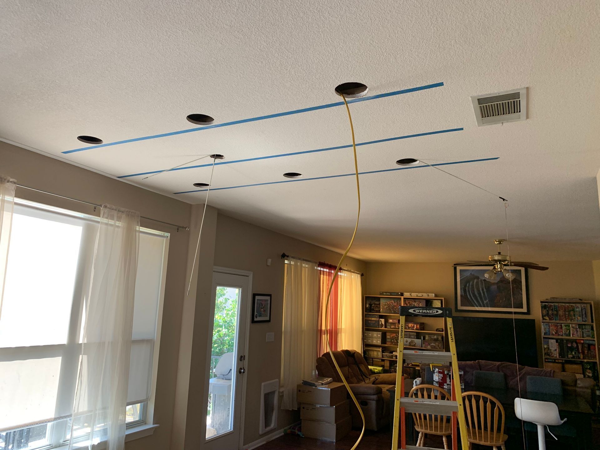 A living room with a ceiling that has lines drawn on it