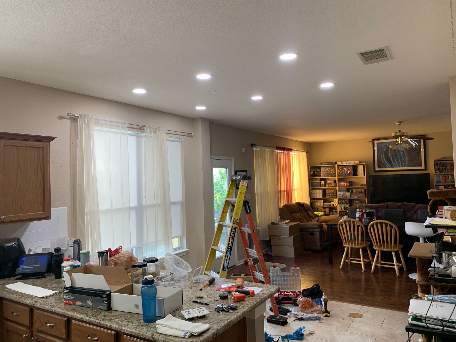 A kitchen and living room are being remodeled in a house.