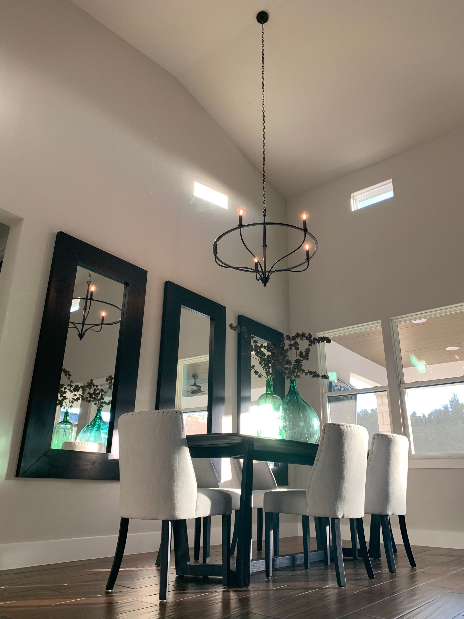 A dining room with a table and chairs and a chandelier