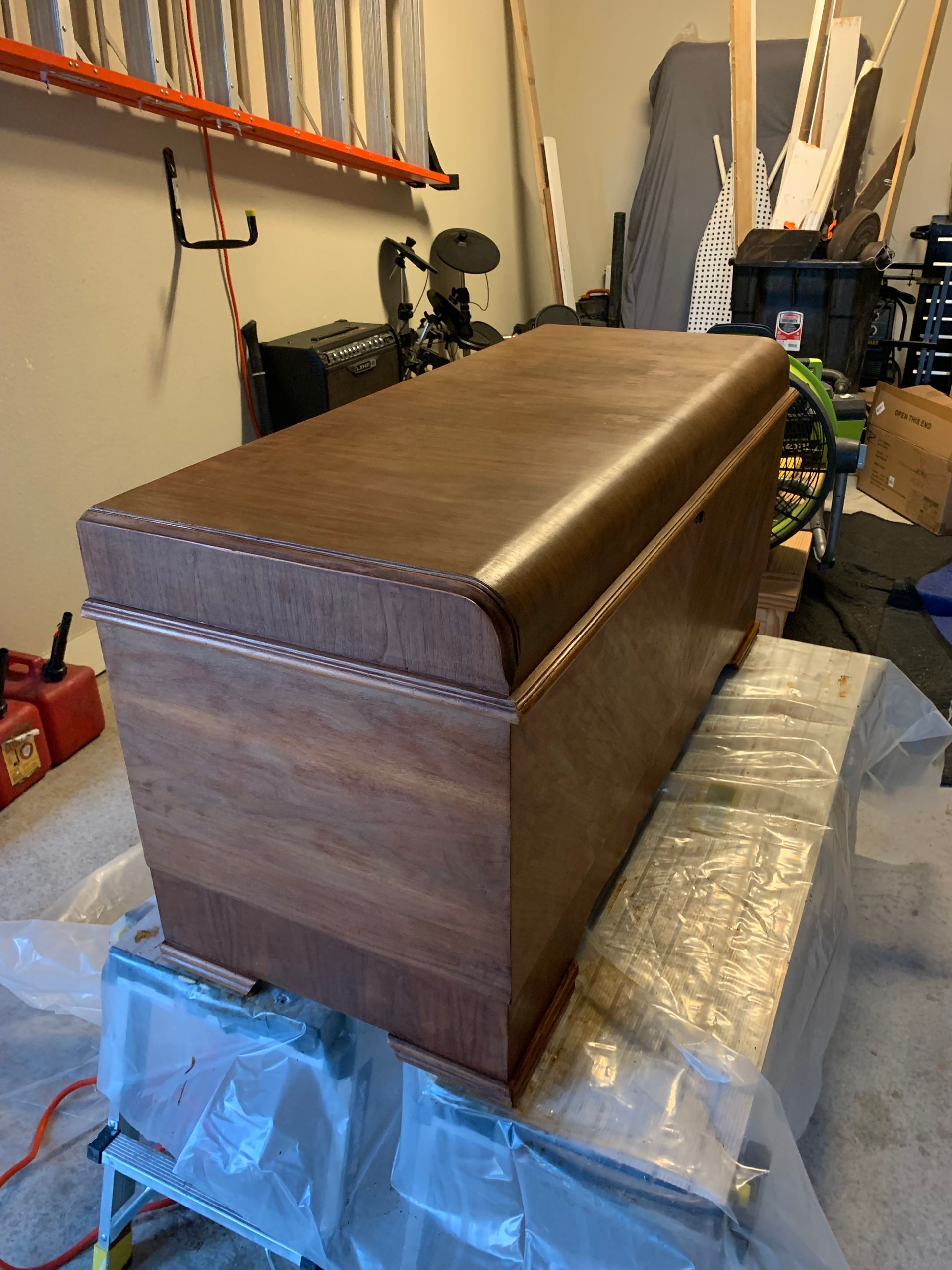 A wooden chest is sitting on top of a table in a garage.