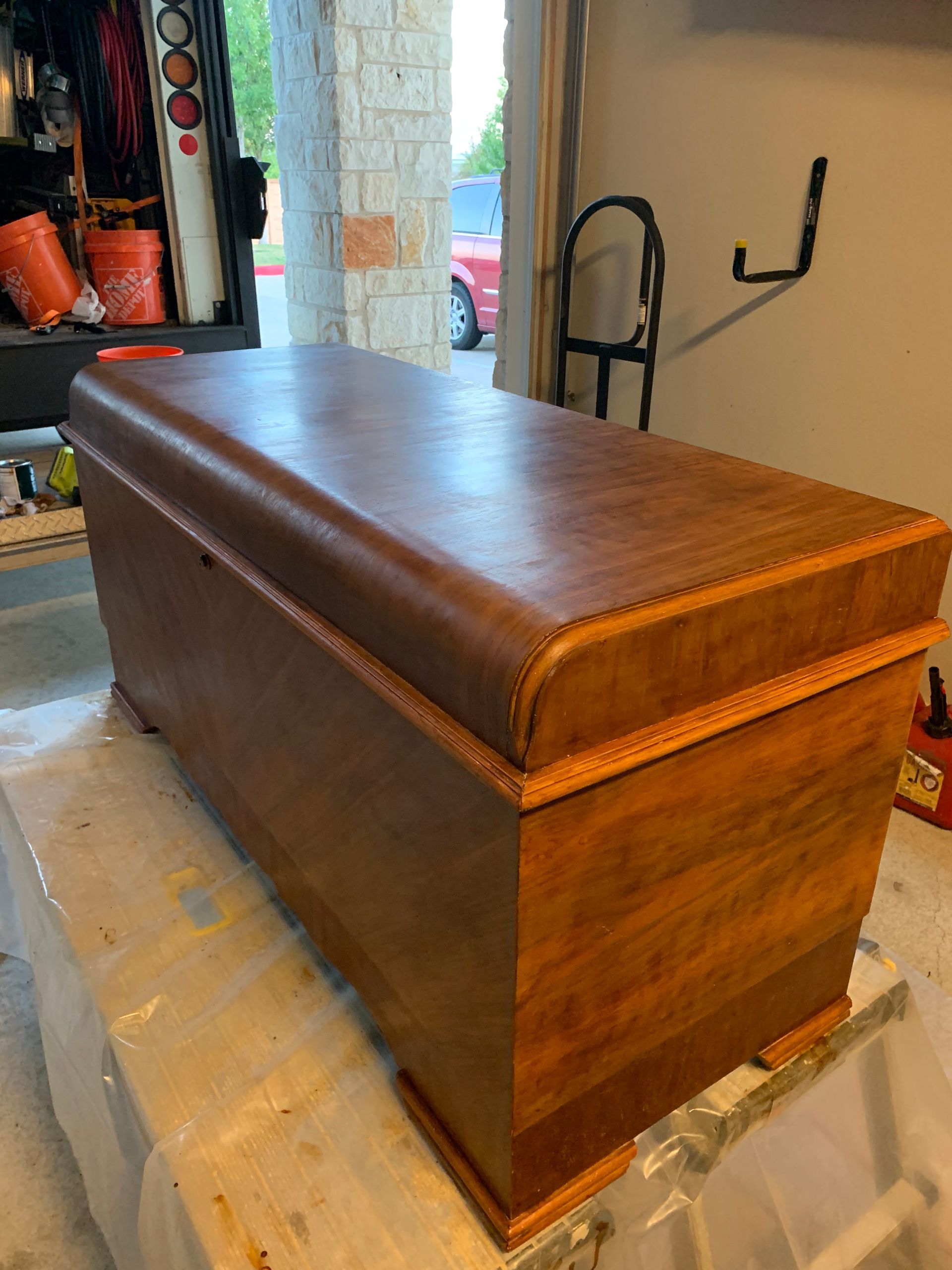 A wooden trunk is sitting on a table in a garage