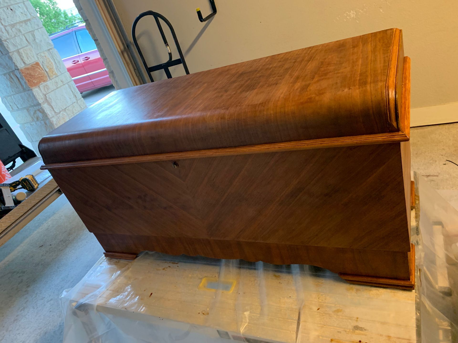 A wooden chest is sitting on top of a white table.