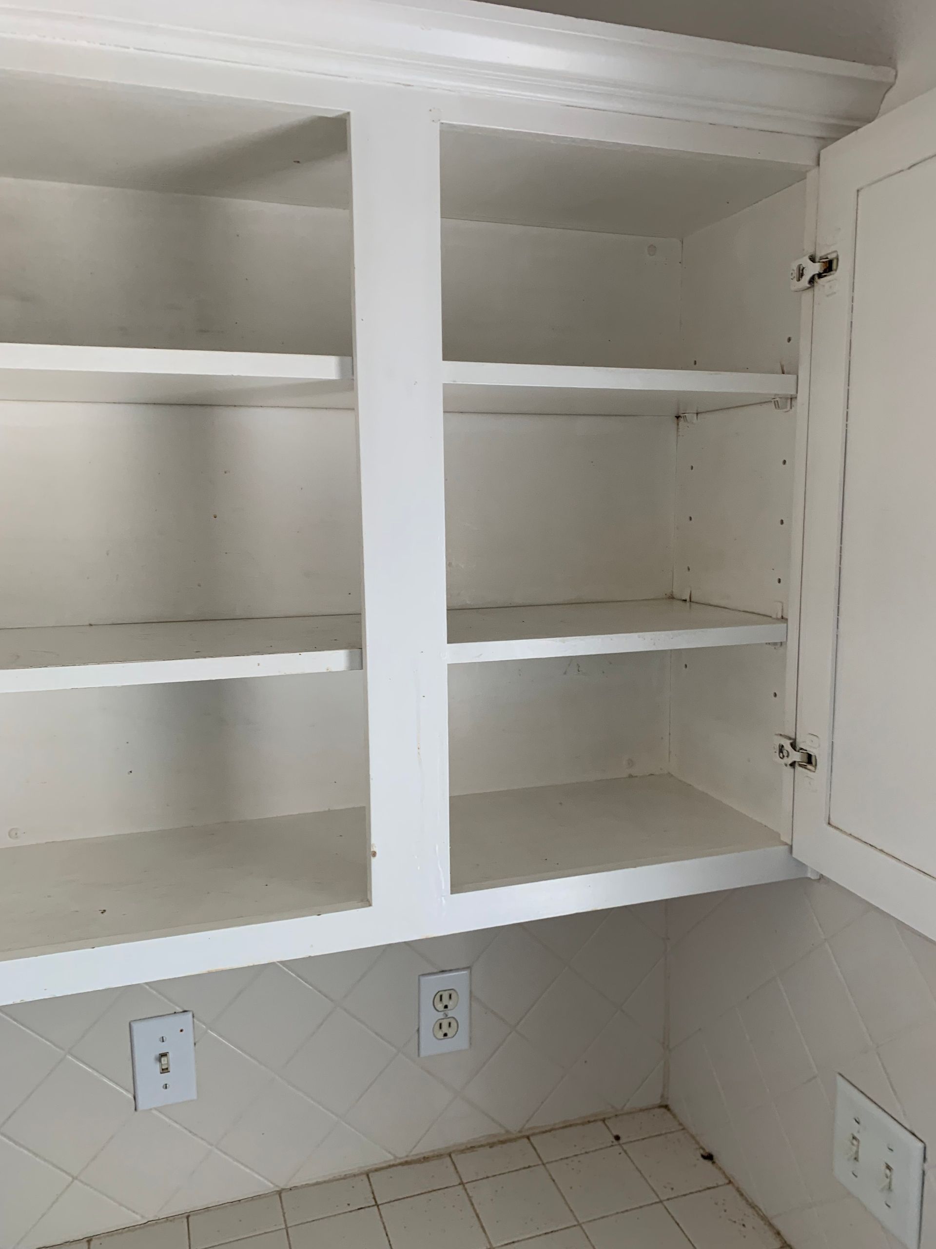 A balcony with a wooden railing and a view of a house.