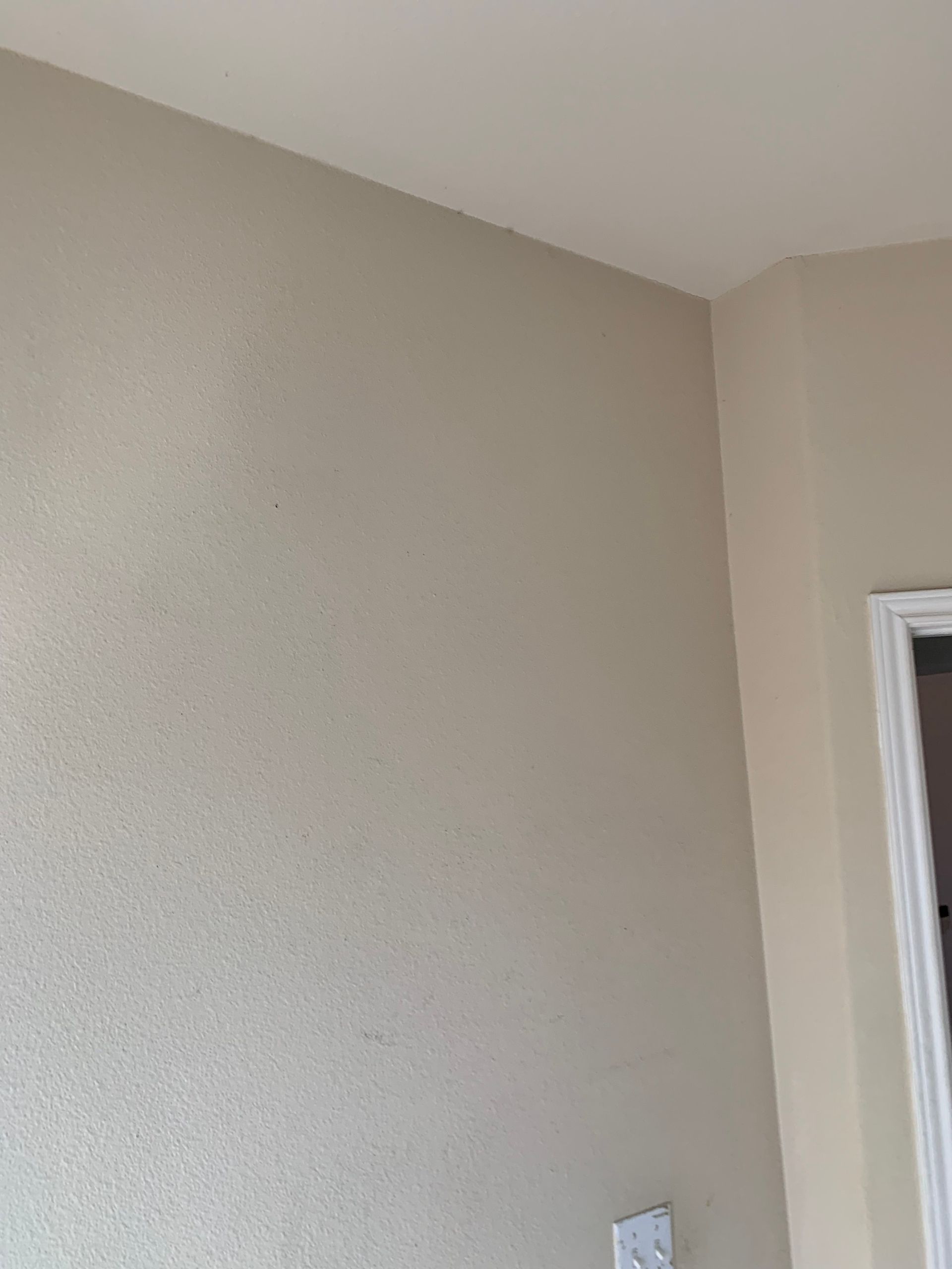 A room with white walls and a door.