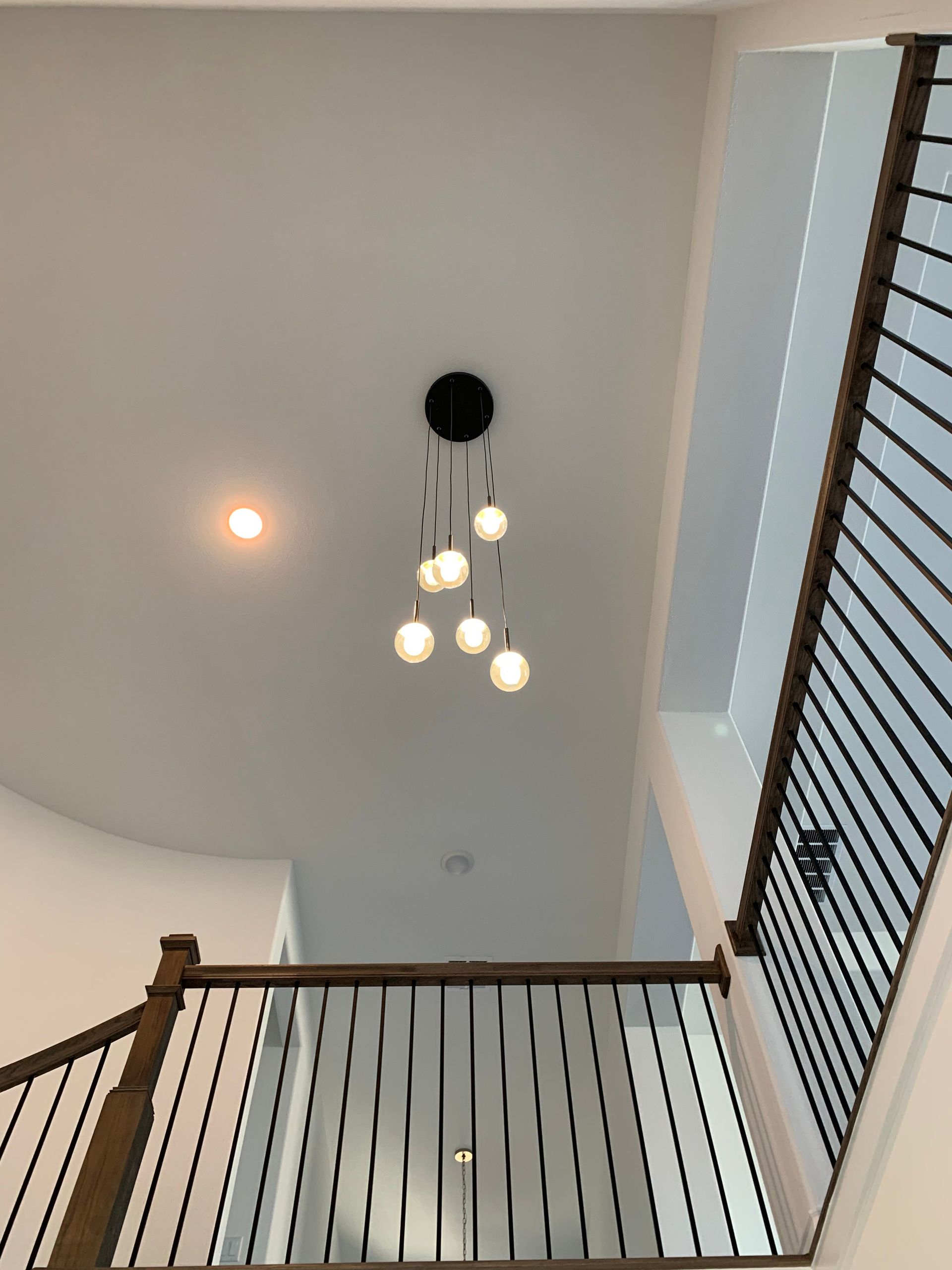 An image showcasing a professional lighting service in action. Skilled technicians are installing and adjusting lighting fixtures in a room, creating an illuminated and welcoming atmosphere.