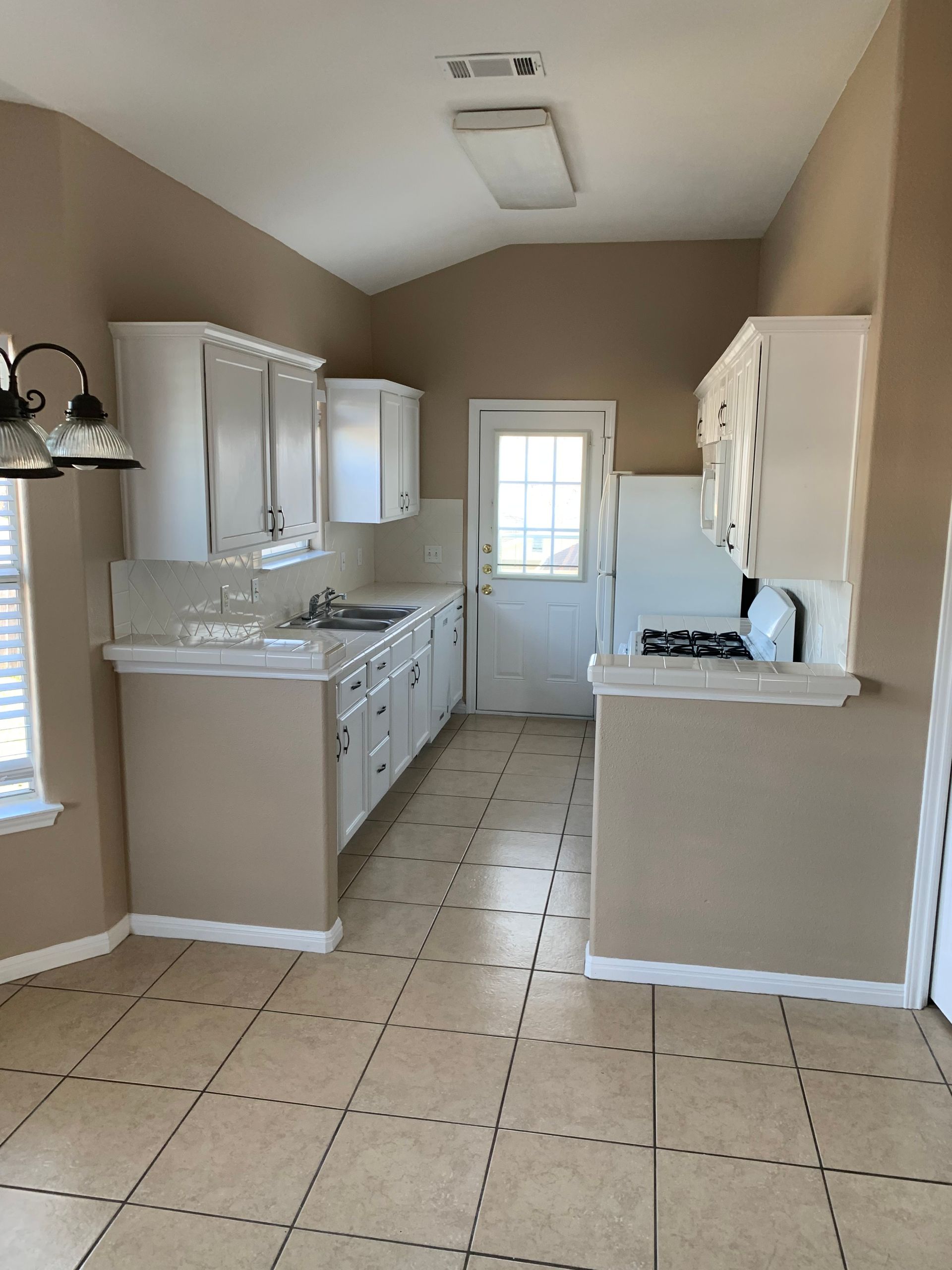 An image showcasing a kitchen remodeling project in progress. Skilled contractors are seen installing new cabinets, countertops, and appliances, transforming the kitchen into a modern and stylish space.