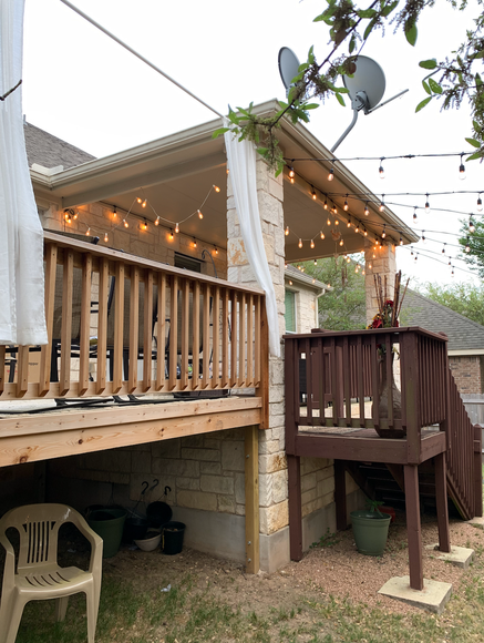 A wooden deck with a satellite dish on the roof.