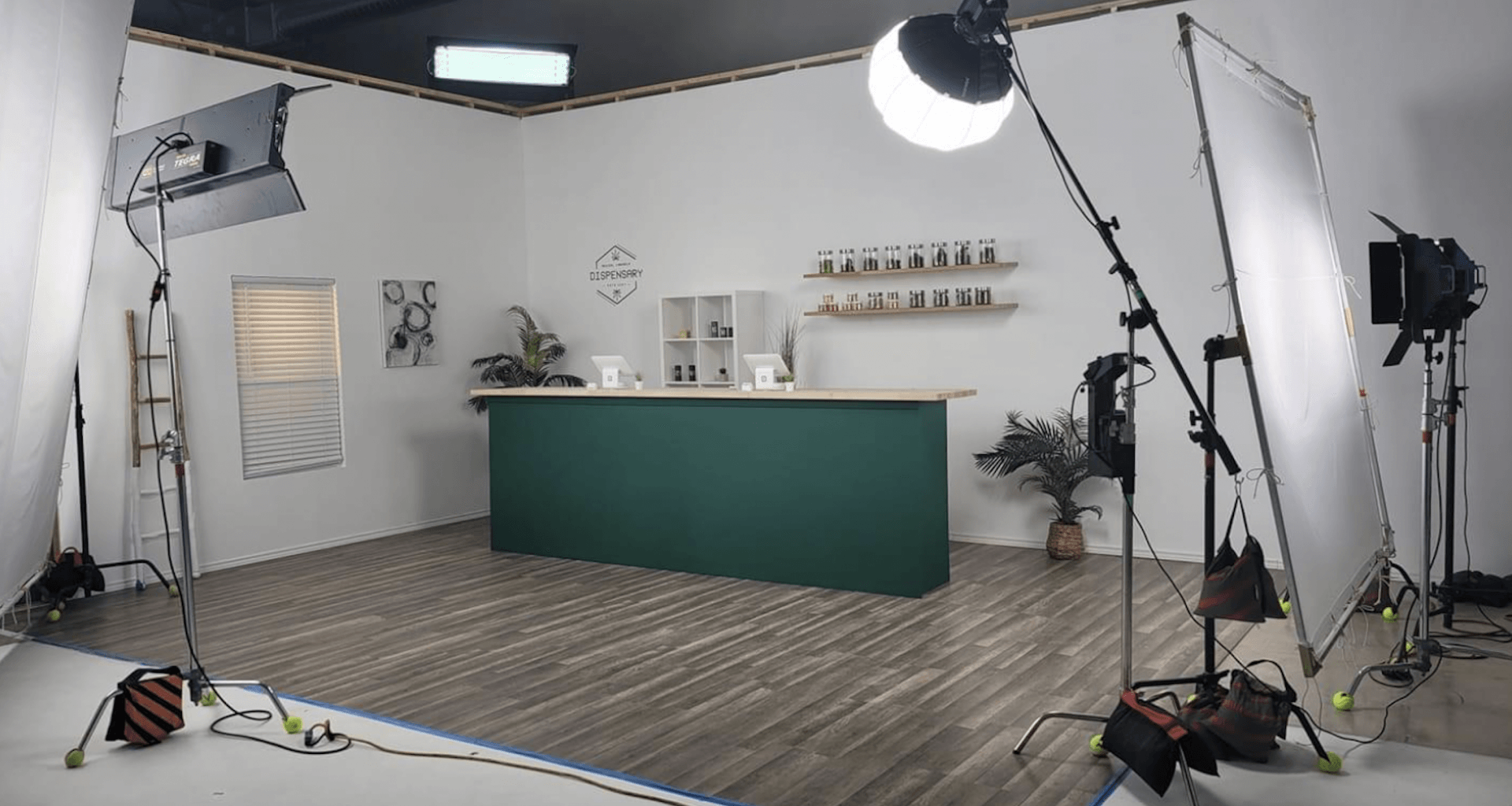A photo studio with a green counter and a lot of lights.