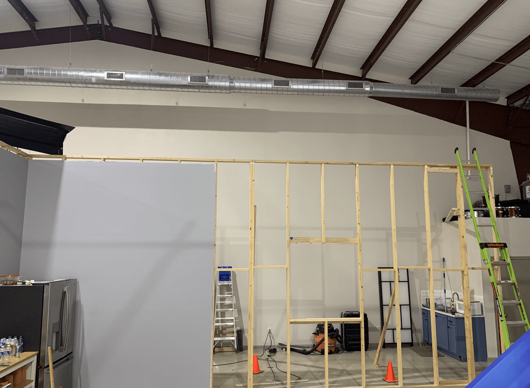 A large room with a ladder in the middle of it.