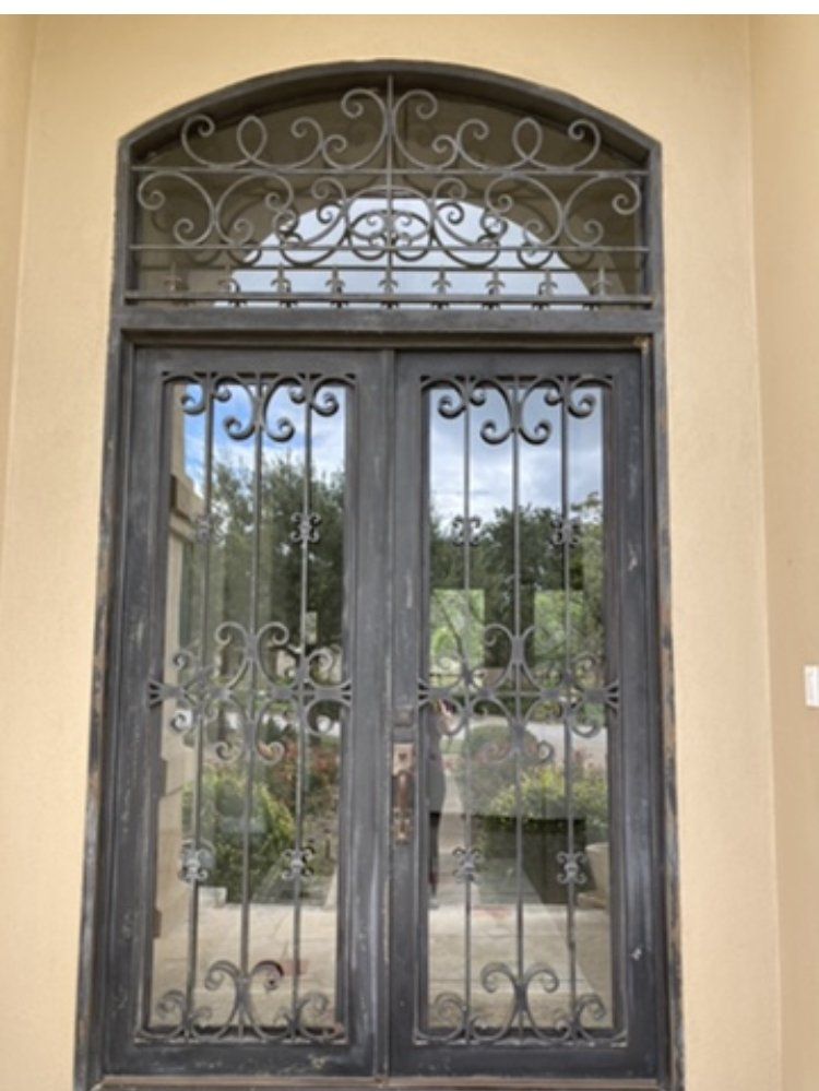 A door with a wrought iron design on it